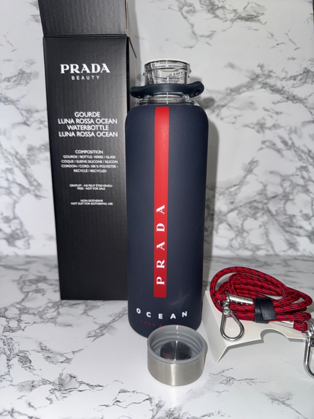 NWT Prada glass water bottle with silicone sleeve
Never used
Still in box